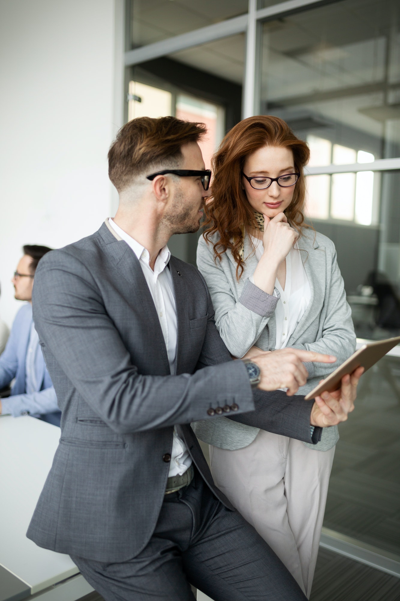 Group of lawyers discussing contract together in office