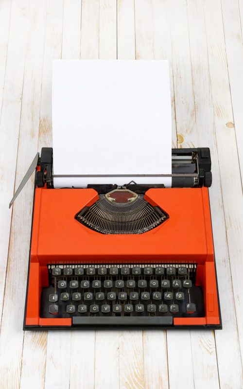 red-typewriter-on-white-wood-plank (1) (1)